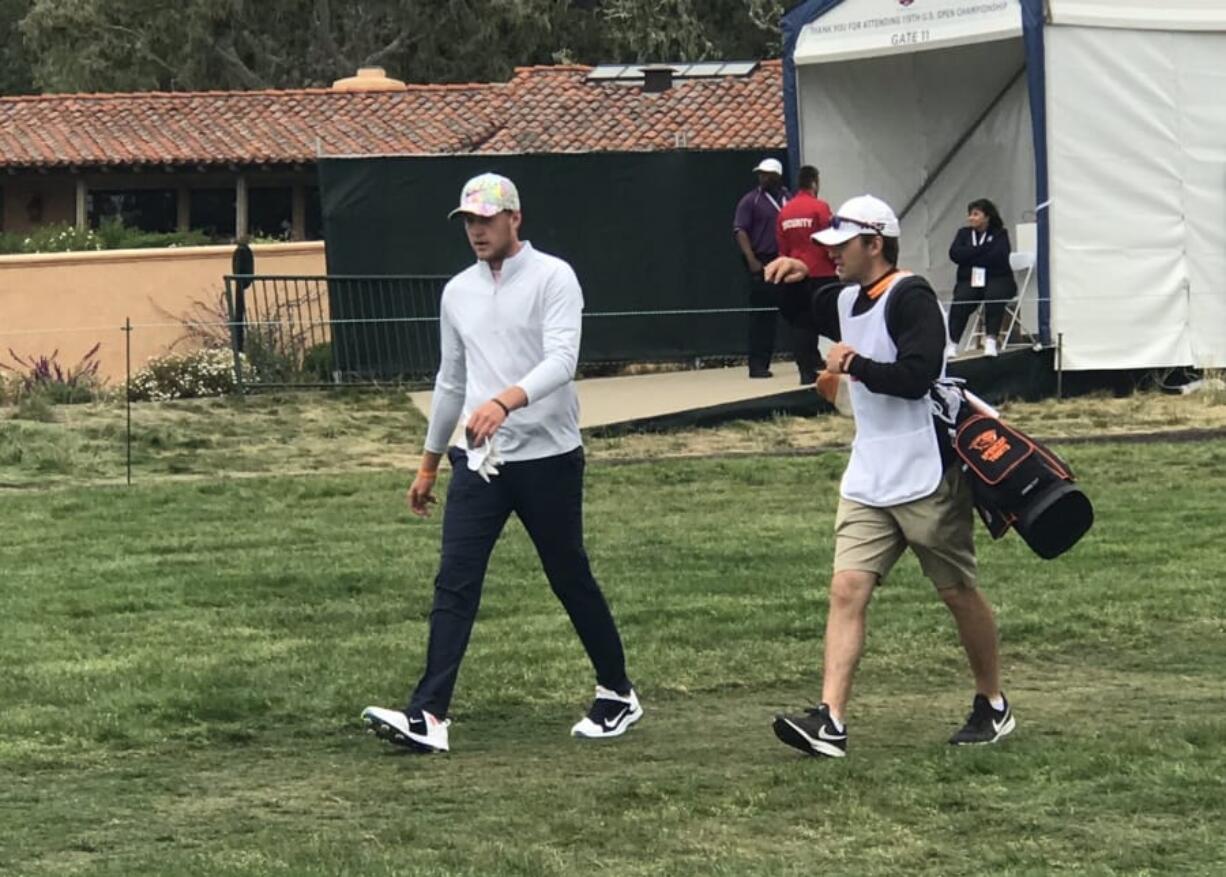 Spencer Tibbits, left, and caddie Keith Lobis walk off the tee during the first round of the U.S. Open at Pebble Beach, Calif., on Thursday.