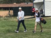 Spencer Tibbits, left, and caddie Keith Lobis walk off the tee during the first round of the U.S. Open at Pebble Beach, Calif., on Thursday.