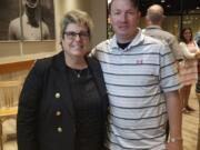 Heritage athletic director Leta Meyer poses with Heritage soccer coach Bryan Housley at an end of the school year sports awards ceremony, where Meyer was honored for her years of service. (Photo courtesy of Heritage High School).