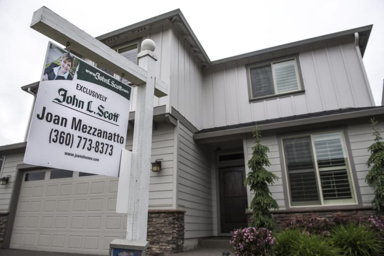 A for-sale sign in front of a home in Felida on May 16.