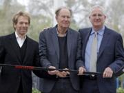 Part-owners, from left to right, Jerry Bruckheimer and David Bonderman pose with Tod Leiweke when Leiweke was named as the president and CEO of the Seattle NHL team in April 2018.