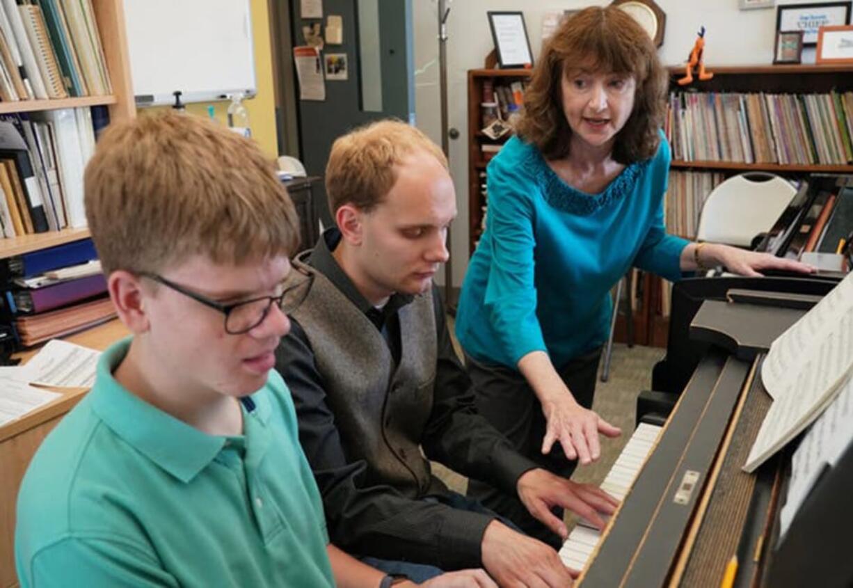 Pianists Noah Johnson, left, and Brandon Leu practices for an upcoming recital as their teacher Diana Bearmon watches and listens. Shari L.