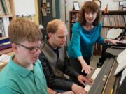 Pianists Noah Johnson, left, and Brandon Leu practices for an upcoming recital as their teacher Diana Bearmon watches and listens. Shari L.