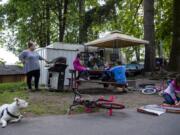 Valerie Guerra barbecues meat and vegetables for her kids outside their trailer at the Lewis River RV Park in Woodland. After being unsheltered and hotel hopping, the family decided to stay in an RV. Guerra and her husband are both working again and the family is hoping to find housing by the end of the year.