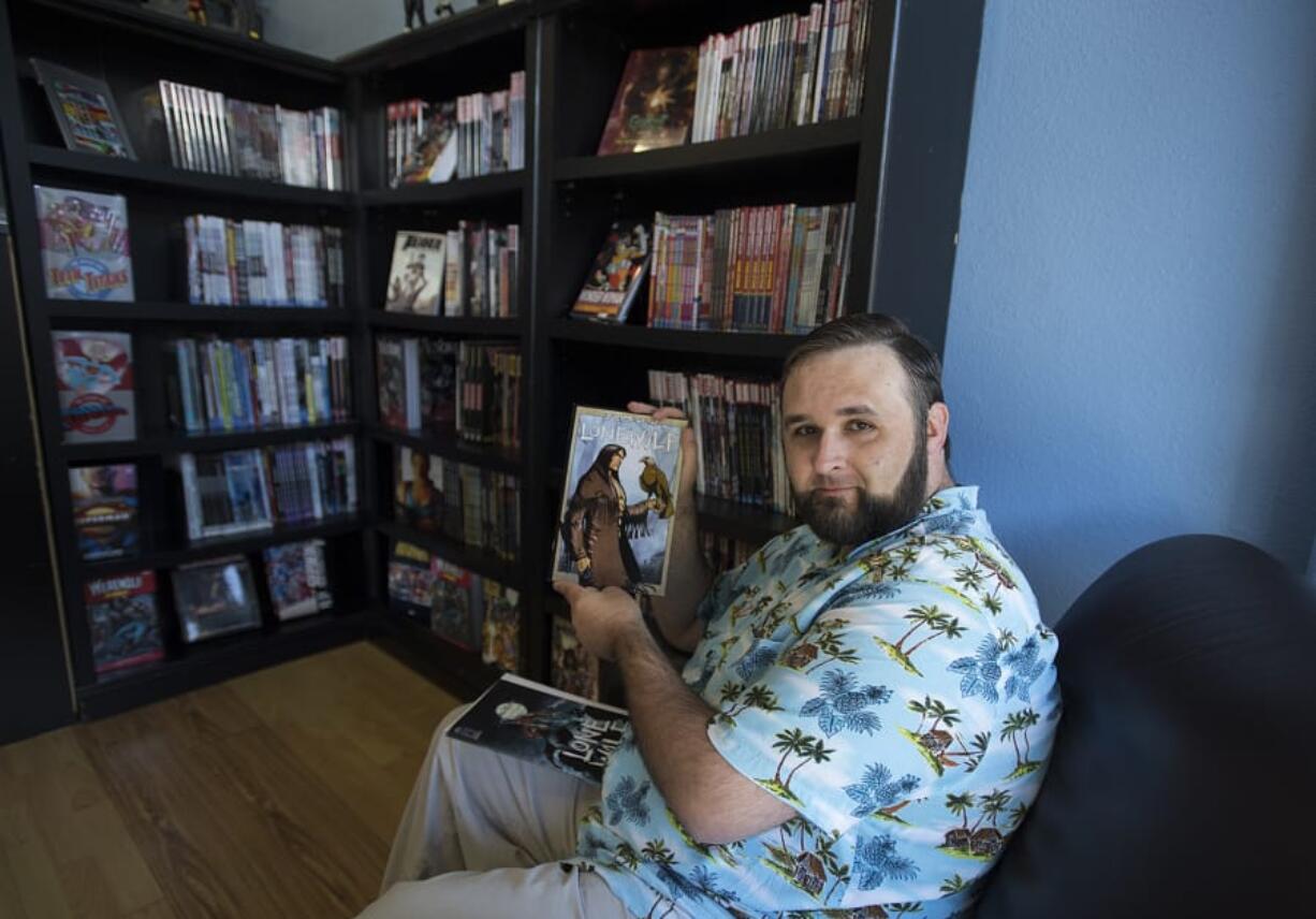 Cowlitz County resident Matthew Merz displays a copy of “Lone Wolf” at I Like Comics in Vancouver. Merz wrote the feature story for an anthology that continues the character’s story.