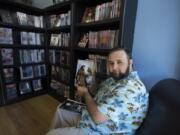 Cowlitz County resident Matthew Merz displays a copy of “Lone Wolf” at I Like Comics in Vancouver. Merz wrote the feature story for an anthology that continues the character’s story.