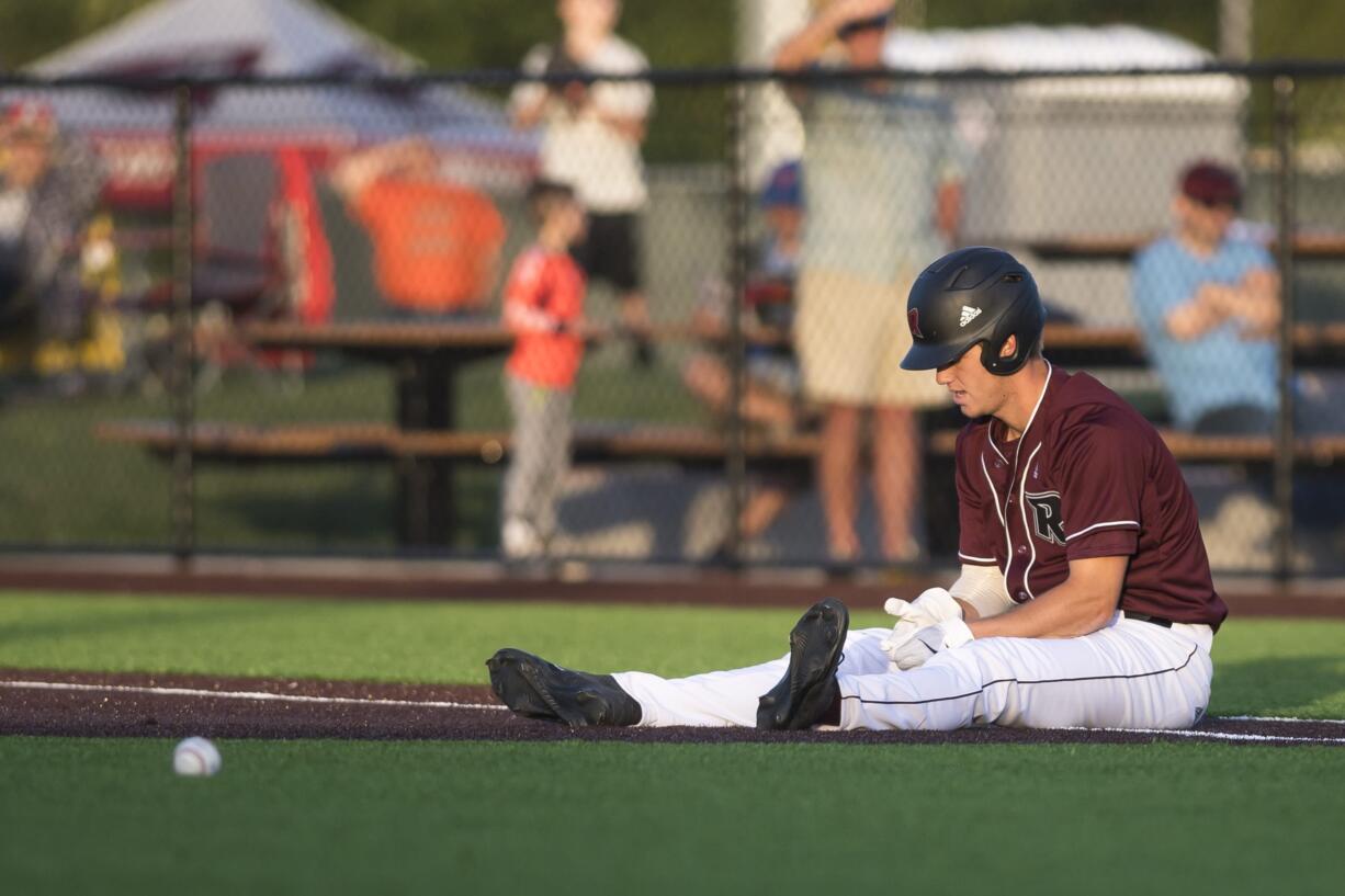 Ridgefield's Cameron Repetti catches his breath at first base after being tagged in a pickle during a game against Yakima at the Ridgefield Outdoor Recreation Center on Tuesday night, June 4, 2019.