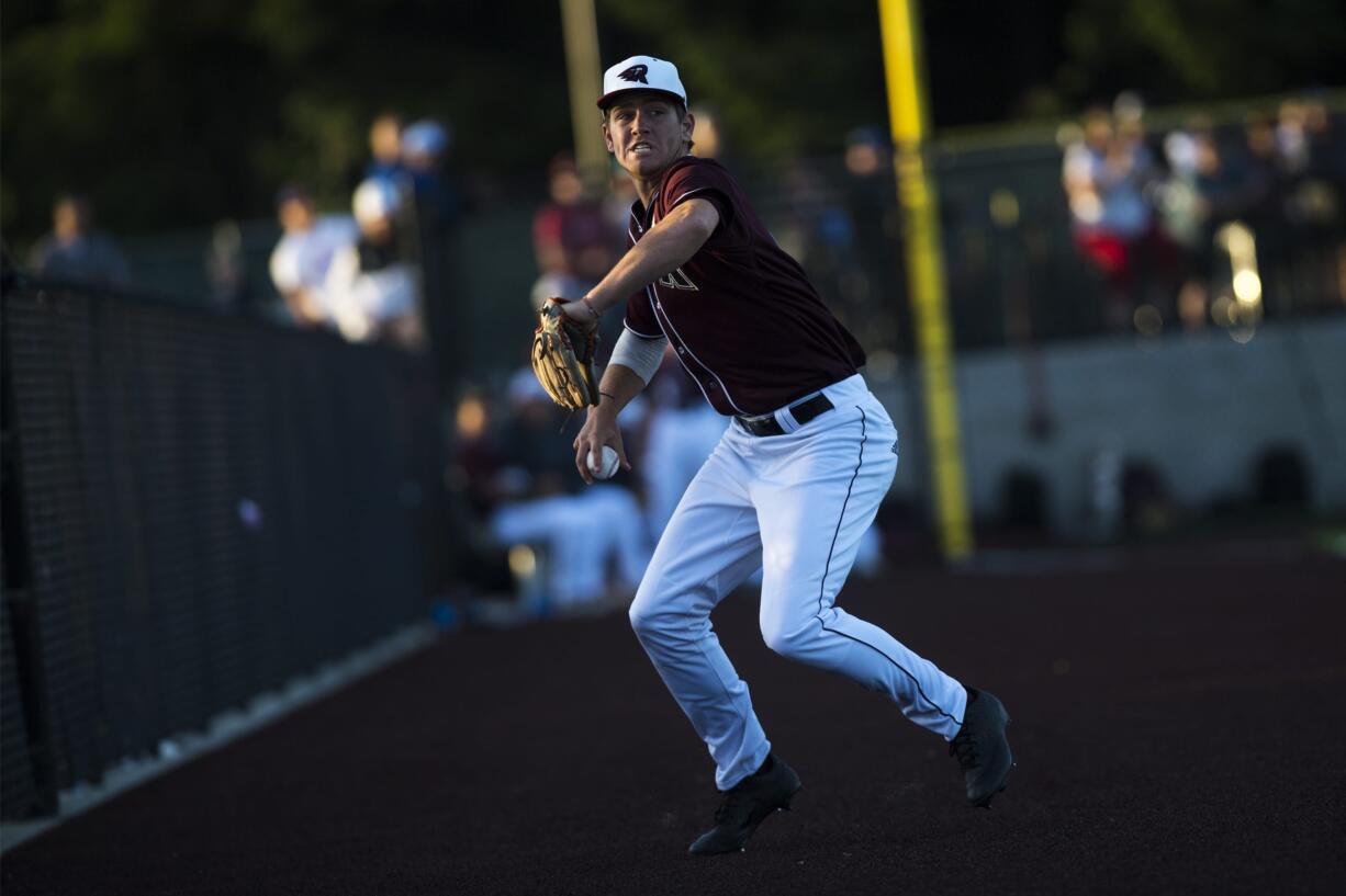 Ridgefield's Cameron Repetti fields a hit to third base during a game against Yakima at the Ridgefield Outdoor Recreation Center on Tuesday night, June 4, 2019.