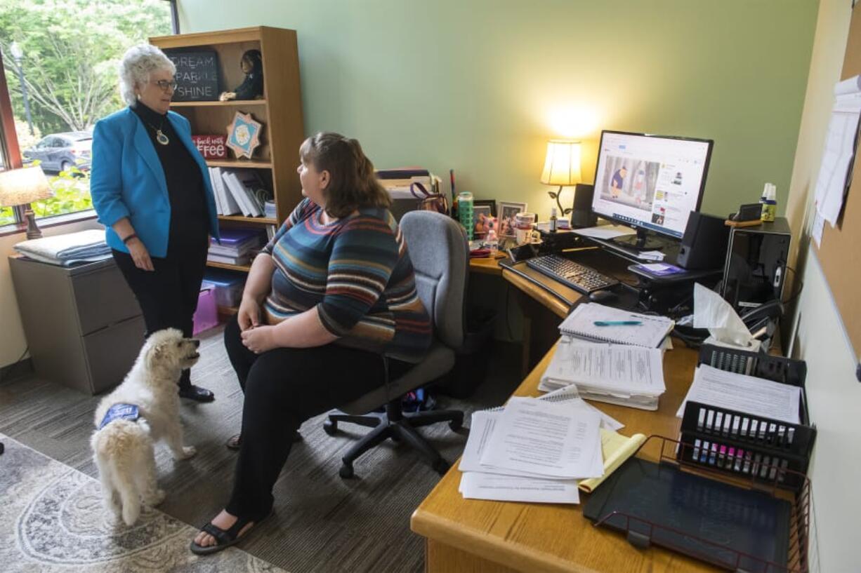 Kim Schneiderman, the executive director of NAMI Southwest Washington, left, talks with Heidi Bjurstrom, program director, in the group’s new offices in downtown Vancouver. Schneiderman said the new location is more accessible. “I wanted to go to people, instead of people coming to us,” she said.