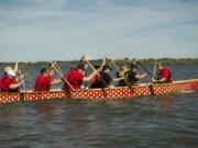 Representatives of Kleen Street Recovery Cafe, a group that helps people with substance abuse recovery, and members of Peace Lutheran Church paddle a dragon boat Monday in preparation for the July 13 Paddle For Life event at Vancouver Lake Regional Park.