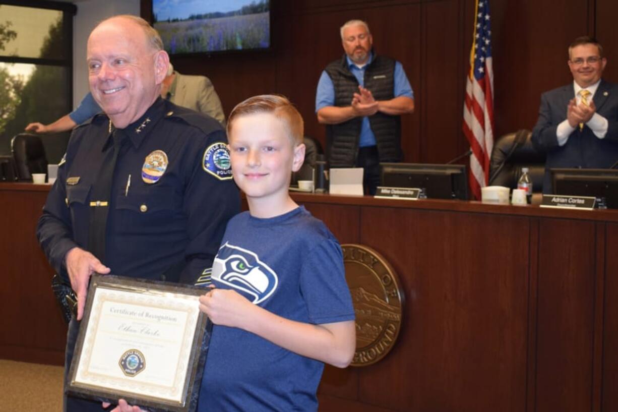 Battle Ground: Battle Ground Police Chief Bob Richardson and Ethan Clarke, 9, who was named an Honorary First Responder by the department for his efforts to save his grandmother after she got trapped underneath her car.