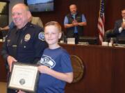 Battle Ground: Battle Ground Police Chief Bob Richardson and Ethan Clarke, 9, who was named an Honorary First Responder by the department for his efforts to save his grandmother after she got trapped underneath her car.