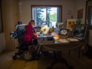 Margie Linn works on her paintings for an art show that was held Friday at Rite Choice Ventilator Speciality adult family home in Vancouver. Linn, who was diagnosed with polio as a teenager and later placed on a ventilator, feels painting is one way she stays active and independent.