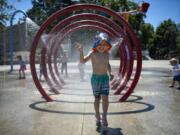 Tanner Heiss, 3, of Ridgefield plays in the water features  at Klineline Pond in Vancouver.