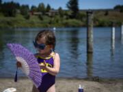 Mara Yedinak, 3, of Portland plays with her fan as her mom gets ready to pack up Tuesday afternoon at Klineline Pond in Vancouver.