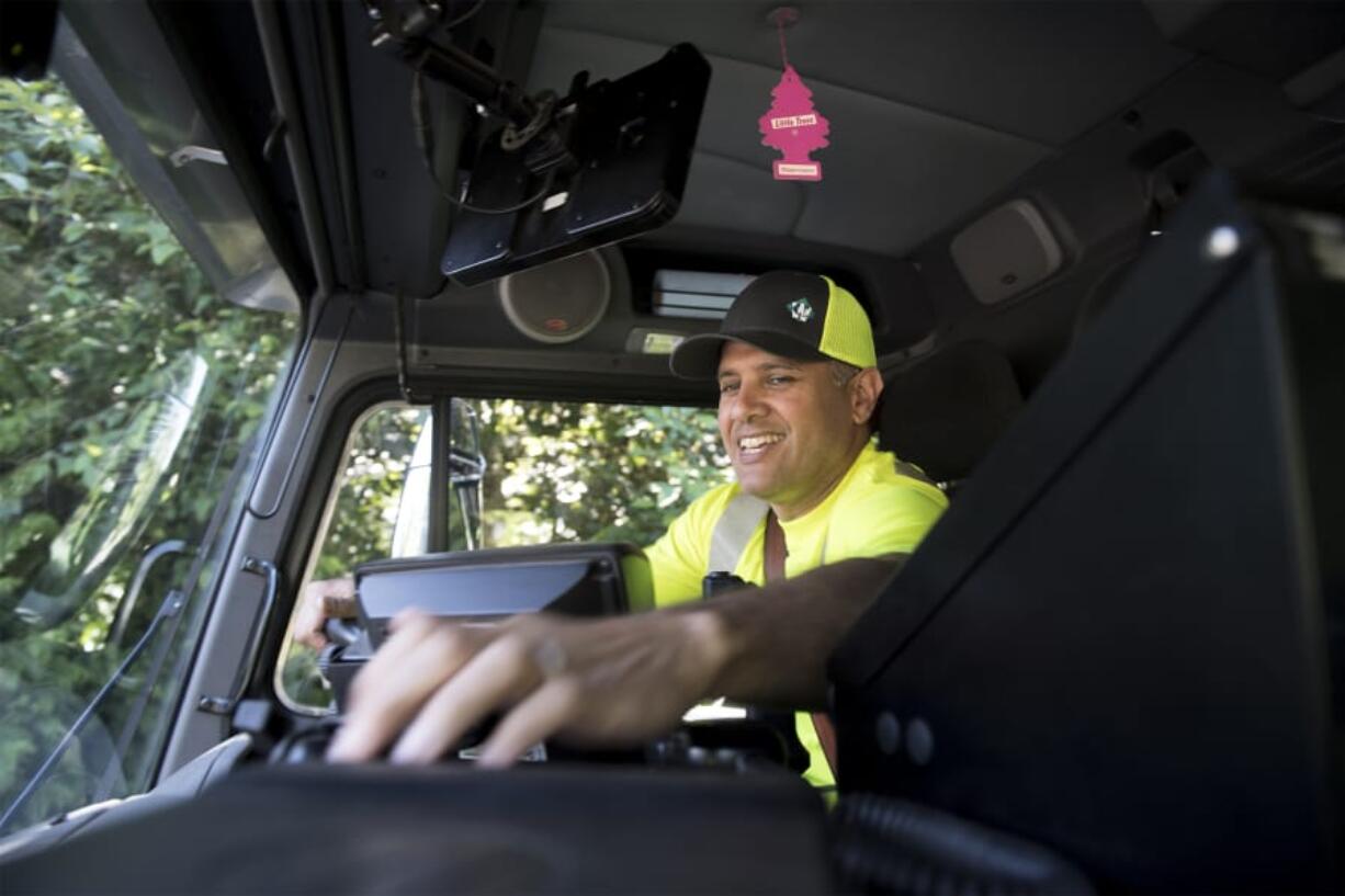 Gabe Duarte, a residential garbage truck driver with Waste Connections, collects garbage in an east Vancouver neighborhood last week. August will mark 15 years on the job for Duarte. The Los Angeles native moved to the area with his father in 1989. He never set out to be a garbage collector. “I think it’s decent. I’ve been able to raise my family, my two kids. The benefits are good, I believe. My wife and daughter have different medication they need. It’s helped with that,” Duarte said.