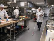 Debra Erickson prepared an orange shrimp dish during her culinary arts final exam at Clark College in Vancouver on Wednesday. Erickson has retinitis pigmentosa, a rare genetic disorder that causes the cells in the retina to deteriorate. Erickson hopes to use her new skills to teach blind people how to cook.