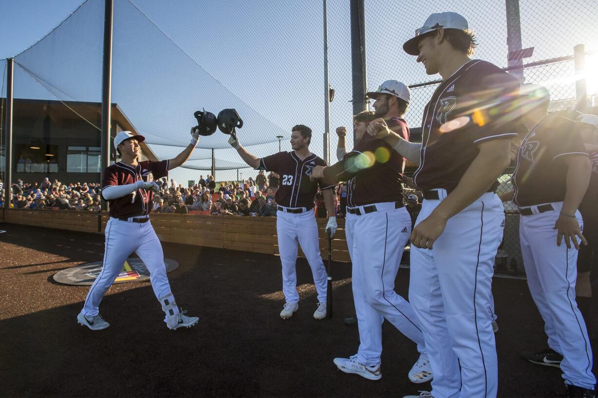 The Raptors' Jonny Weaver, left, celebrates his home run in the second inning during their match against the Port Angeles Lefties at the Ridgefield Outdoor Recreation Complex on Friday night, June 14, 2019.