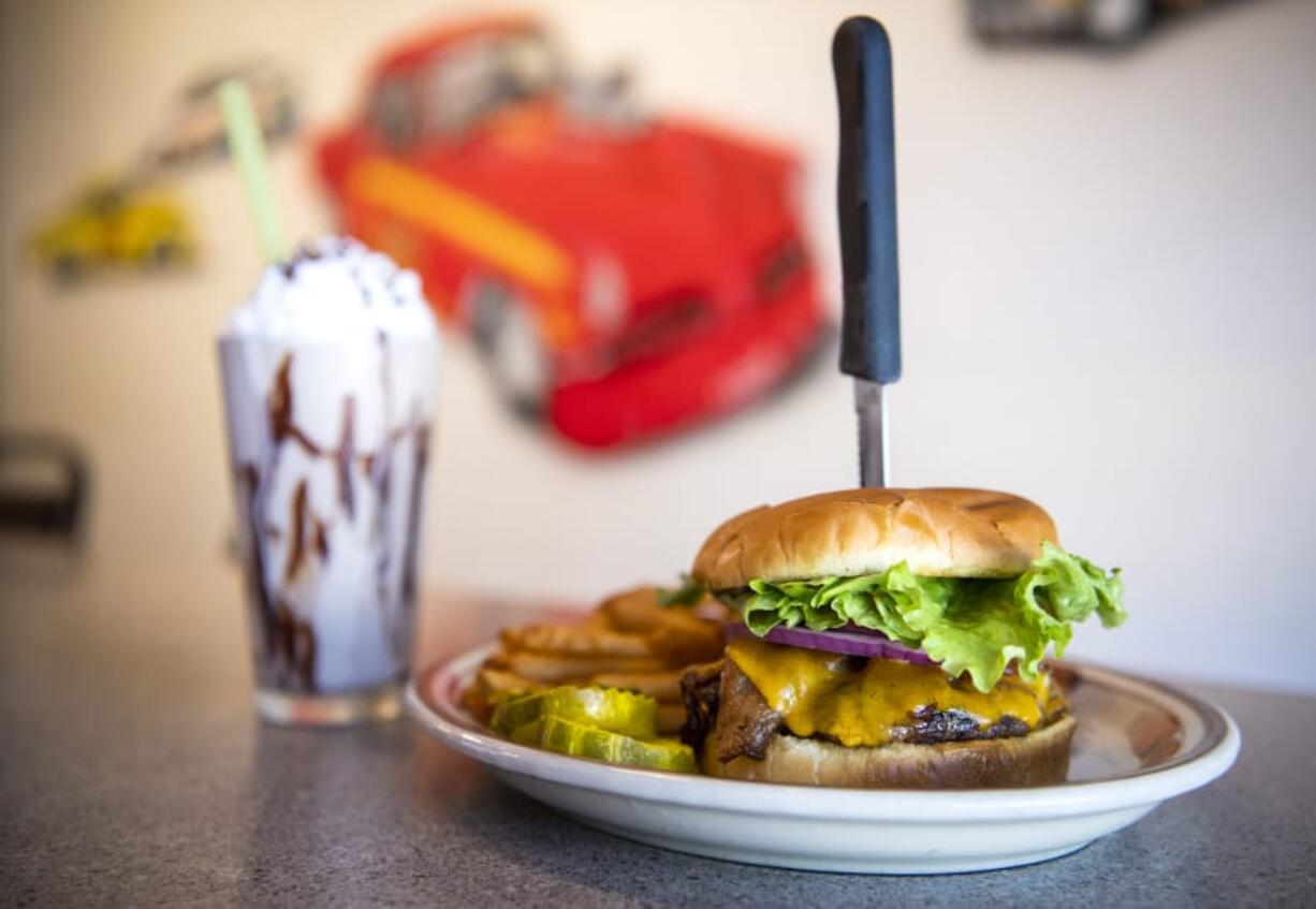 A hand-scooped chocolate shake and the bacon cheeseburger at Benny’s Rod & Custom Pizza Cafe.