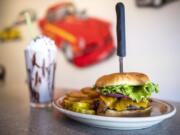 A hand-scooped chocolate shake and the bacon cheeseburger at Benny’s Rod & Custom Pizza Cafe.