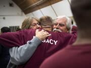 Howard Seaworth, center, embraces his stepmother Brenda Seaworth, left, and father Stephen Seaworth after the commencement ceremony for Clark College graduates at Larch Corrections Center in Yacolt on Wednesday. Seaworth recently completed his General Educational Development certificate.