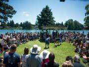 Spectators watch the Frog Jump contest at Woodland Planters Days on Saturday. It was a raucous affair — a few frogs made a break for it.