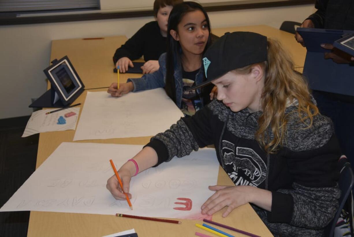 Washougal: Jemtegaard Middle School students Anastasia Kirillov and Jada’lynn Iriarte work on posters for hallways to inspire positive thoughts. The school recently won the Whole Child Award from the Washington State Association for Supervision and Curriculum Development, which honors a school that has created a positive culture for student development.