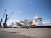 Workers unload 49-meter Vestas wind turbine blades at the Port of Vancouver on Wednesday, June 26, 2019.