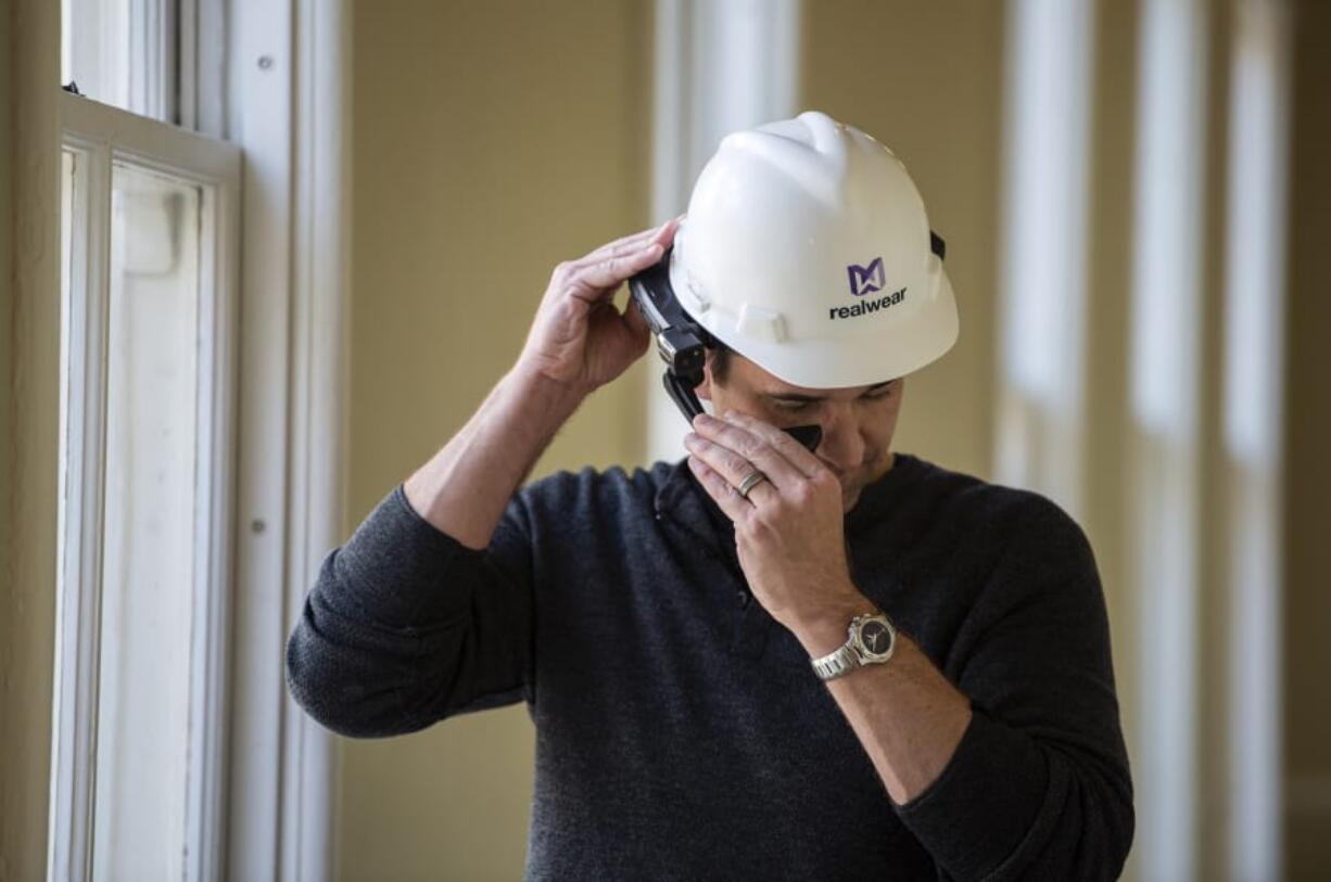 RealWear CEO Andy Lowery adjusts one of the company’s HMT-1 headsets, a hands-free Android computer system for industrial workers, at the RealWear headquarters in Vancouver on Friday. The company announced that it has secured $80 million in a new funding round.