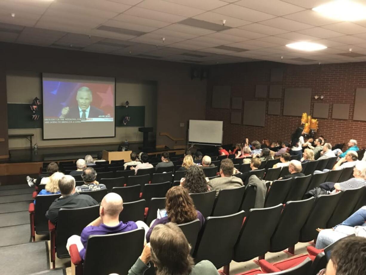 Local residents watch the Democratic presidential debate Wednesday night at Clark College’s Foster Auditorium.