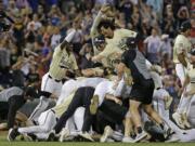 Vanderbilt players celebrate after defeating Michigan to win Game 3 of the NCAA College World Series baseball finals in Omaha, Neb., Wednesday, June 26, 2019.