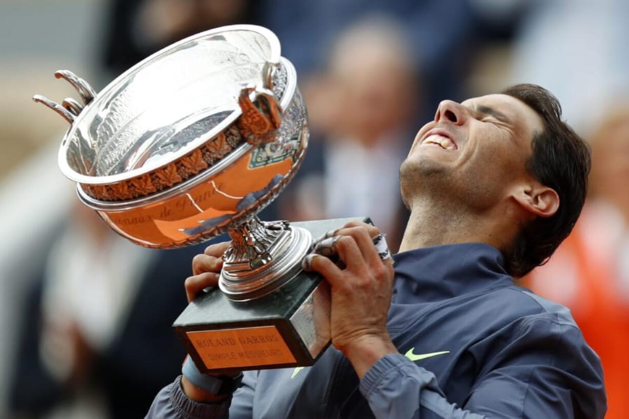 Spain’s Rafael Nadal lifts the cup after defeating Austria’s Dominic Thiem in their men’s final match of the French Open tennis tournament at the Roland Garros stadium in Paris, Sunday, June 9, 2019. Nadal won 6-3, 5-7, 6-1, 6-1.