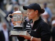 Australia’s Ashleigh Barty kisses the trophy as she celebrates winning her women’s final match of the French Open tennis tournament against Marketa Vondrousova of the Czech Republic in two sets 6-1, 6-3, at the Roland Garros stadium in Paris, Saturday, June 8, 2019.