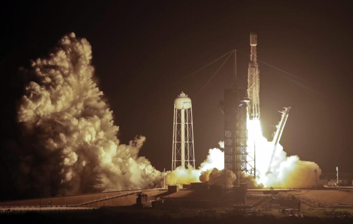 A SpaceX Falcon heavy rocket lifts off from pad 39A at the Kennedy Space Center in Cape Canaveral, Fla., early Tuesday, June 25, 2019. The Falcon rocket has a payload military and scientific research satellites.