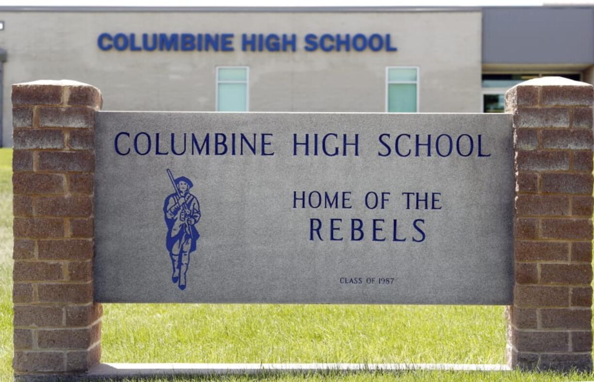 Signs outside Columbine High School are photographed, Thursday, June 13, 2019, in Littleton, Colo. The school district is considering the demolition of Columbine, the scene of a mass assault more than 20 years ago, and rebuilding the current school.