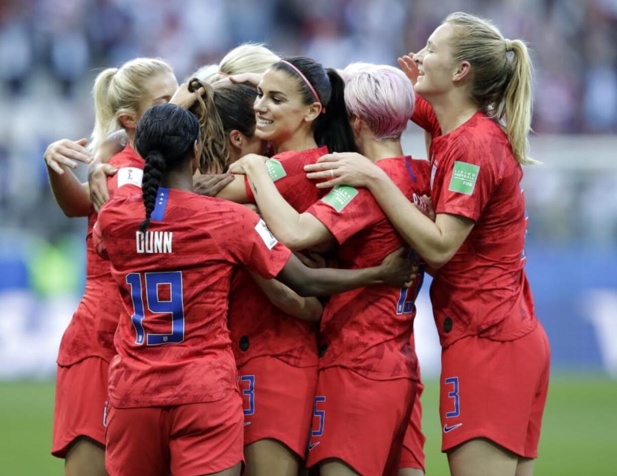 United States’ Alex Morgan, center, celebrates after scoring the opening goal during the Women’s World Cup Group F soccer match between United States and Thailand at the Stade Auguste-Delaune in Reims, France, Tuesday, June 11, 2019.