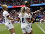 United States’ Megan Rapinoe is congratulated by teammates after scoring her team’s firs goal during the Women’s World Cup quarterfinal soccer match between France and the United States at Parc des Princes in Paris, France, Friday, June 28, 2019.