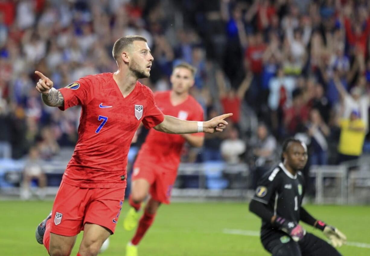 United States' Paul Arriola (7) celebrates after scoring a goal against Guyana goalie Akel Clarke, lower right, during the first half of a CONCACAF Gold Cup soccer match Tuesday, June 18, 2019, in St. Paul, Minn.