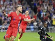 United States' Paul Arriola (7) celebrates after scoring a goal against Guyana goalie Akel Clarke, lower right, during the first half of a CONCACAF Gold Cup soccer match Tuesday, June 18, 2019, in St. Paul, Minn.