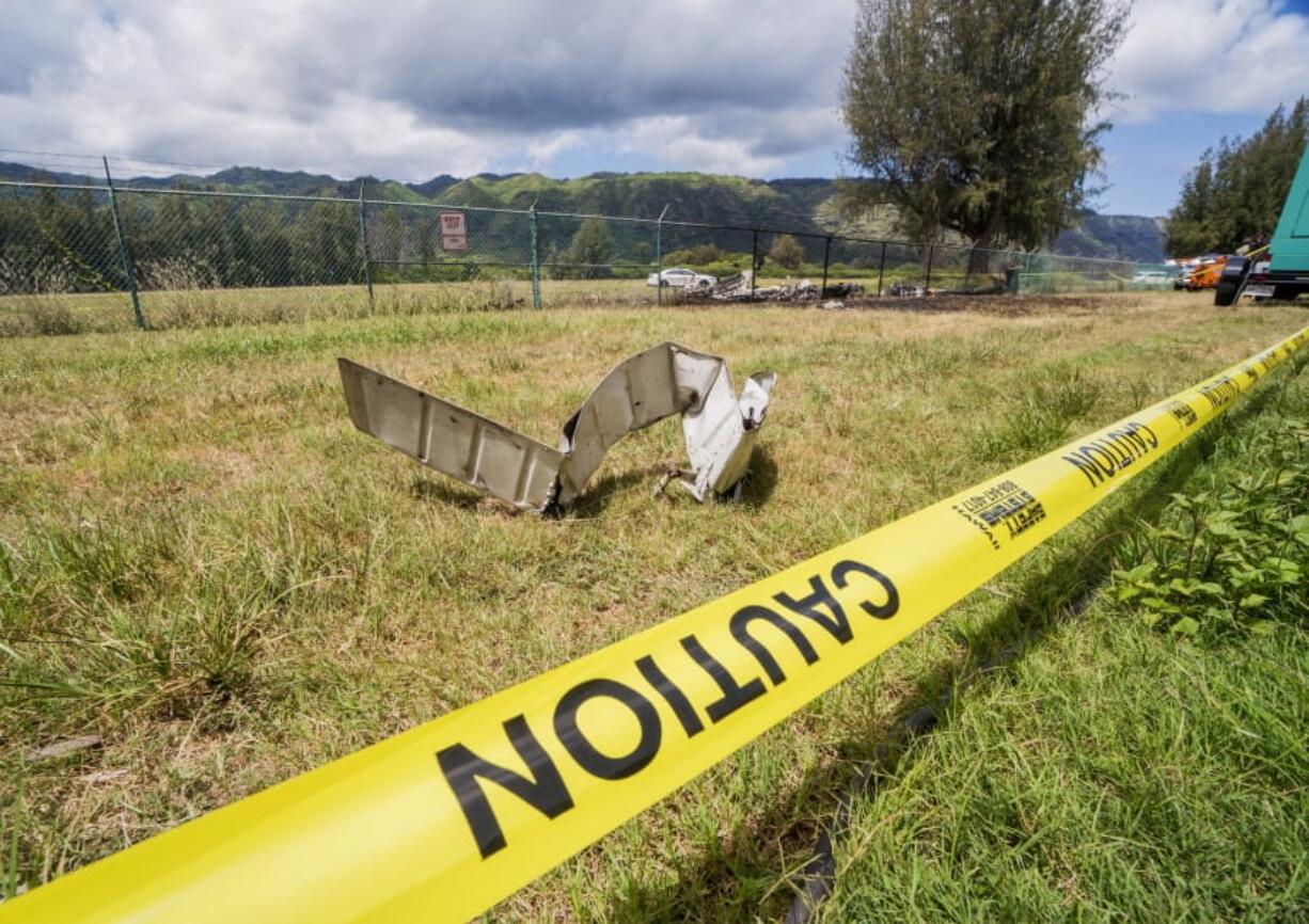 A Beechcraft King Air twin-engine plane crashed Friday evening killing multiple people and leaving wreckage near a chain link fence surrounding Dillingham Airfield seen Saturday, June 22, 2019, in Mokuleia, Hawaii. No one aboard the skydiving plane survived the crash. The flight was operated by the Oahu Parachute Center skydiving company.