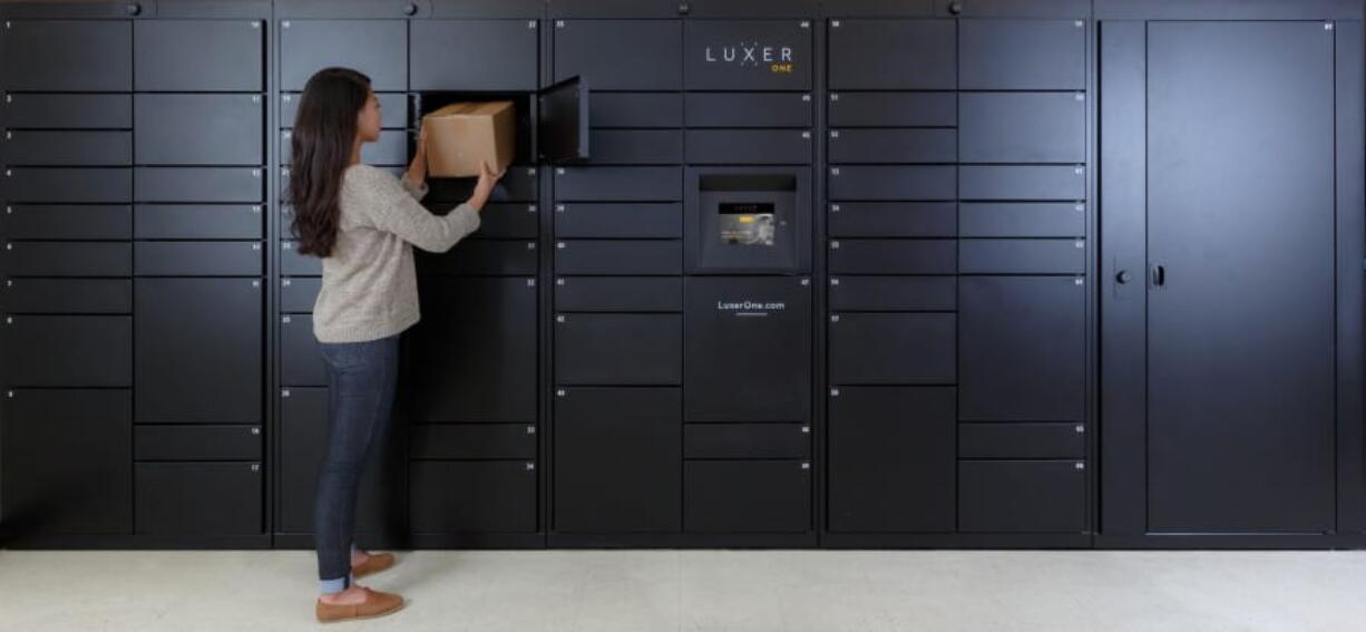 A woman removes a package from one of Luxer’s access lockers in San Francisco.