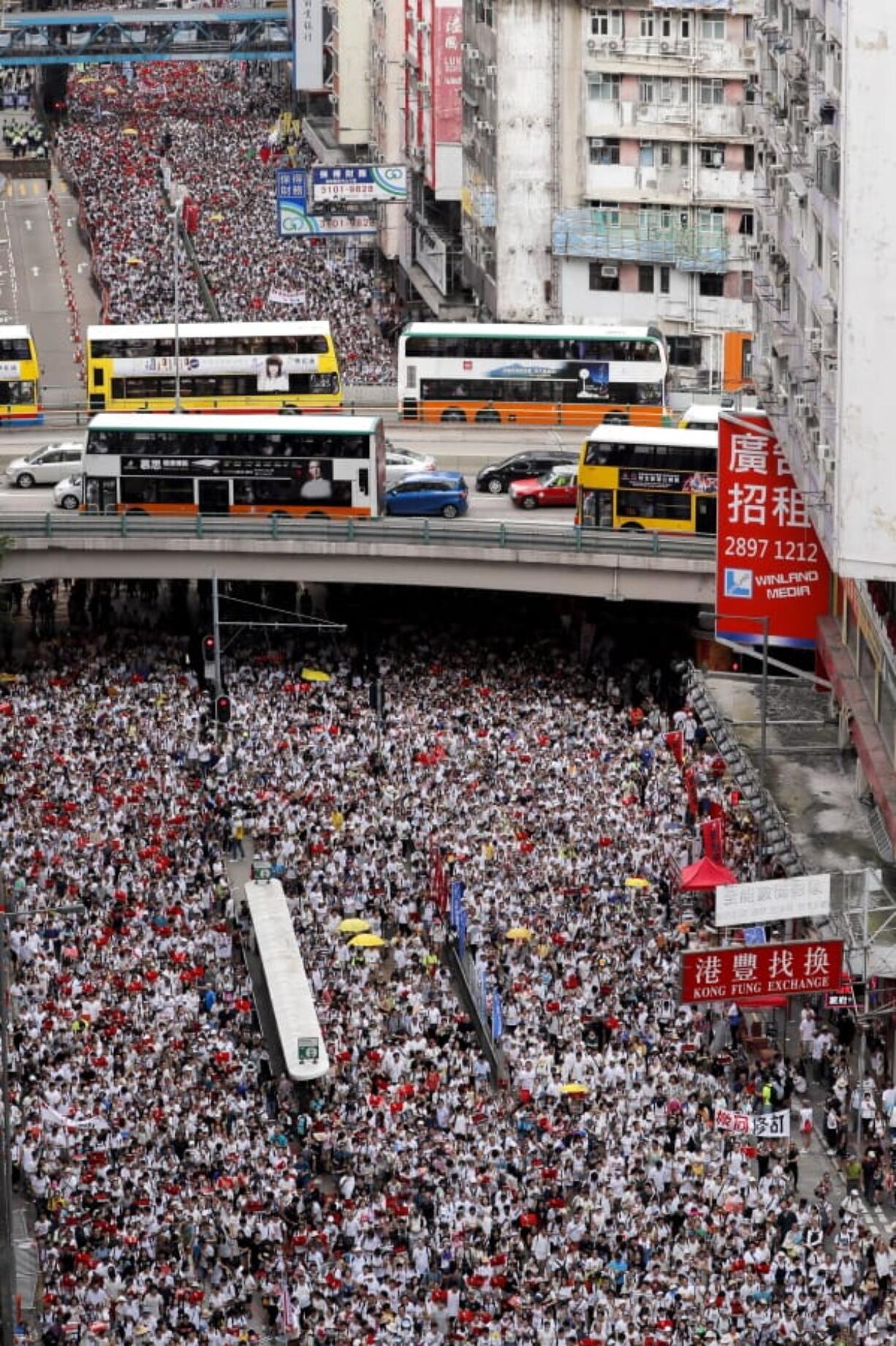 Protesters march in a rally against the proposed amendments to an extradition law in Hong Kong, Sunday, June 9, 2019.