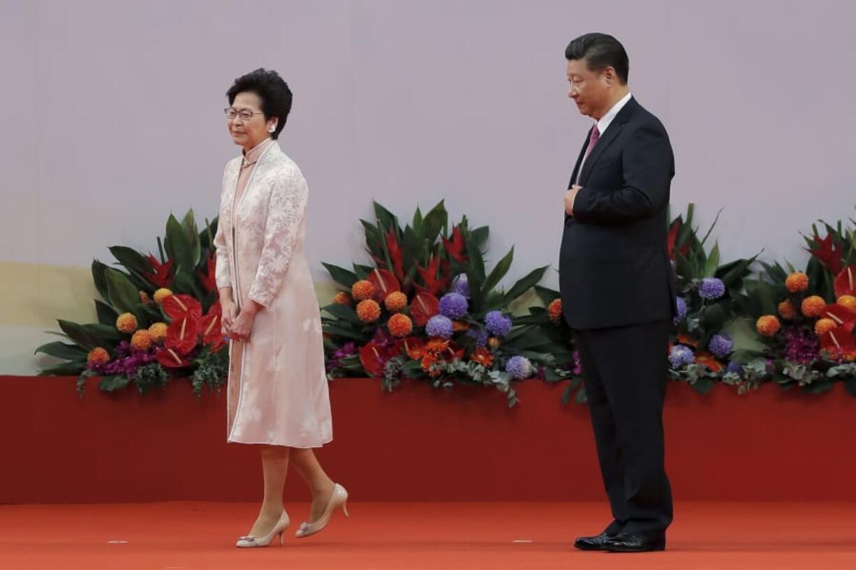 FILE - In this Saturday, July 1, 2017, file photo, Chinese President Xi Jinping, right, looks at Hong Kong’s new Chief Executive Carrie Lam after administering the oath for a five-year term in office at the Hong Kong Convention and Exhibition Center in Hong Kong.