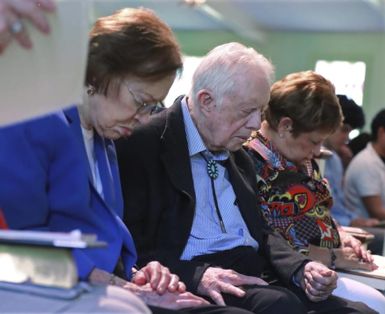 President Jimmy Carter and Rosalynn Carter bow their heads in prayer with members and visitors during the worship service at Maranatha Baptist Church less than a month after the 39th U.S. president and Plains native fell breaking his hip, on Sunday, June 9, 2019, in Plains, Ga.