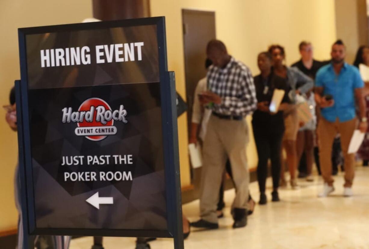 In this Tuesday, June 4, 2019 photo, job applicants line up at the Seminole Hard Rock Hotel & Casino Hollywood during a job fair in Hollywood, Fla. On Monday, June 10, the Labor Department reports on job openings and labor turnover for April.