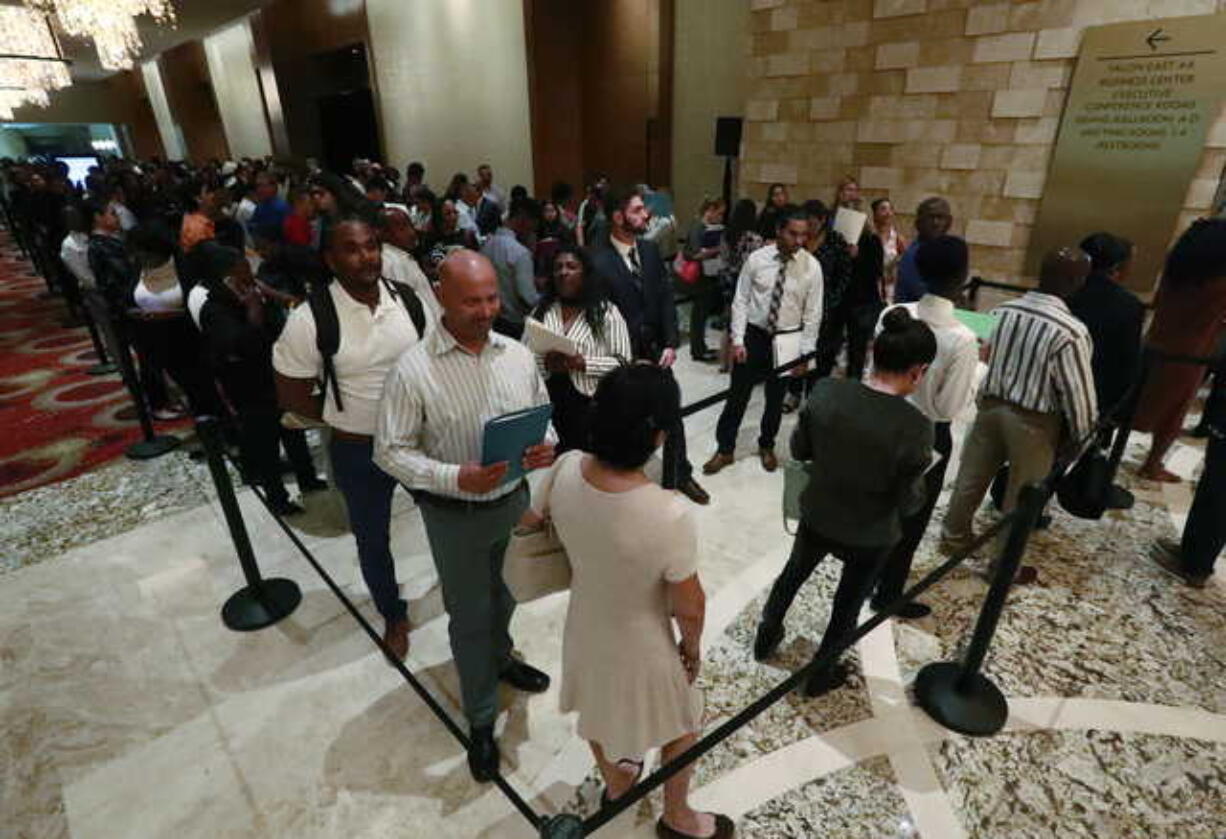 In this Tuesday, June 4, 2019 photo, job applicants line up at the Seminole Hard Rock Hotel & Casino Hollywood during a job fair in Hollywood, Fla. On Friday, June 7, the U.S. government issues the May jobs report.