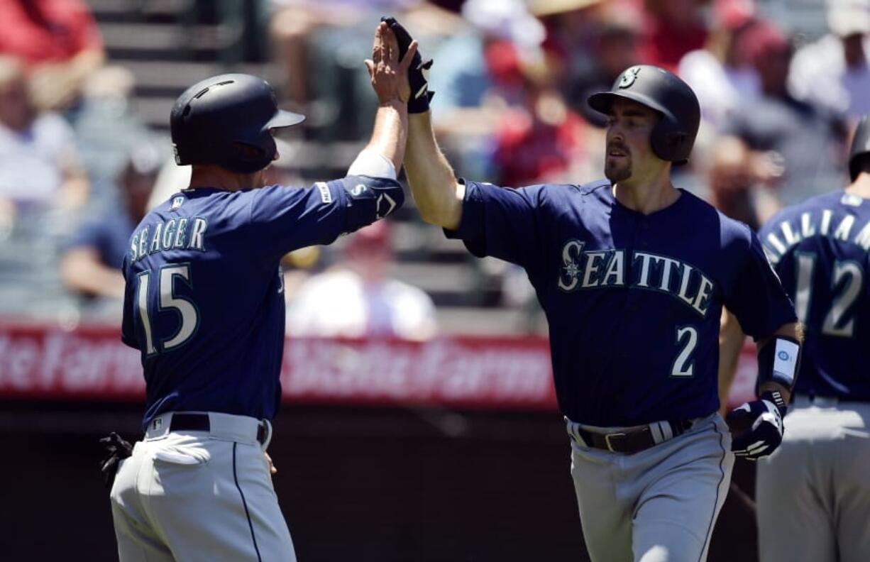 Seattle Mariners’ Tom Murphy, right, is congratulated by Kyle Seager after hitting a two-run home run during the second inning of a baseball game against the Los Angeles Angels, Sunday, June 9, 2019, in Anaheim, Calif. (AP Photo/Mark J.