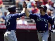 Seattle Mariners’ Tom Murphy, right, is congratulated by Kyle Seager after hitting a two-run home run during the second inning of a baseball game against the Los Angeles Angels, Sunday, June 9, 2019, in Anaheim, Calif. (AP Photo/Mark J.