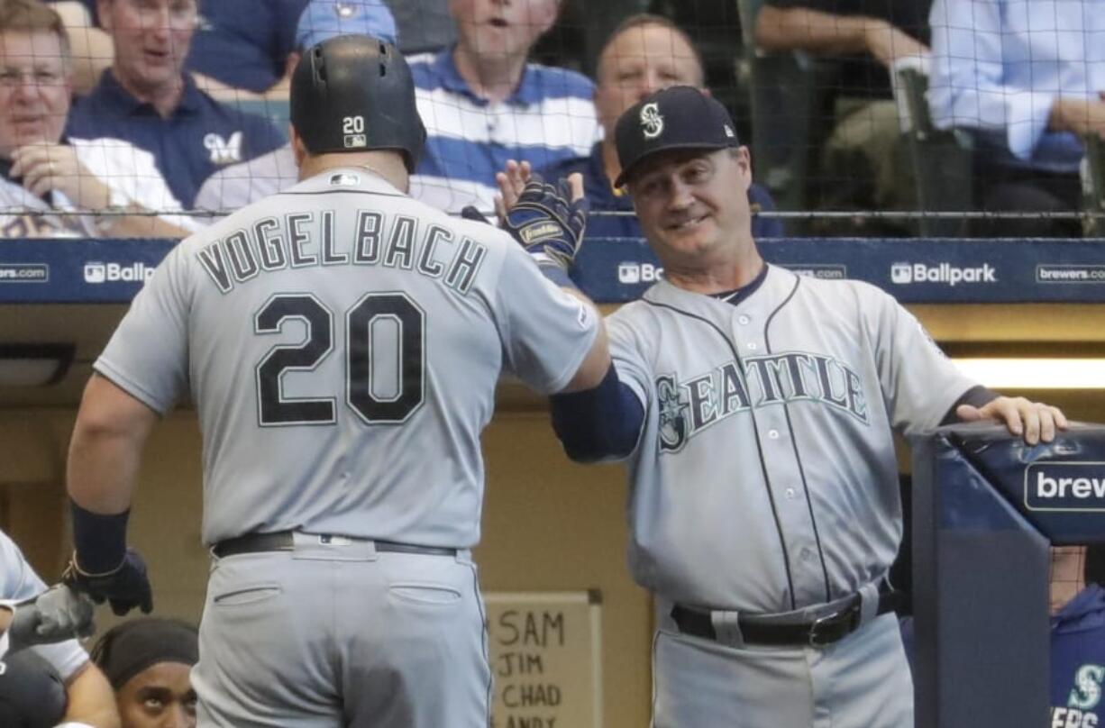 Seattle Mariners’ Daniel Vogelbach is congratulated by manager Scott Servais after hitting a home run during the third inning of a baseball game against the Milwaukee Brewers Tuesday, June 25, 2019, in Milwaukee.