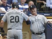 Seattle Mariners’ Daniel Vogelbach is congratulated by manager Scott Servais after hitting a home run during the third inning of a baseball game against the Milwaukee Brewers Tuesday, June 25, 2019, in Milwaukee.